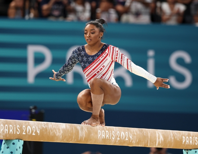 Simone Biles on a balance beam at the 2024 Olympics.